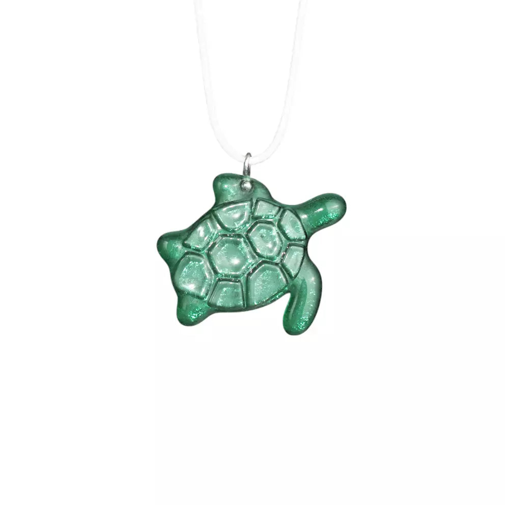 Emerald stained glassturtle-shaped necklace on a white background