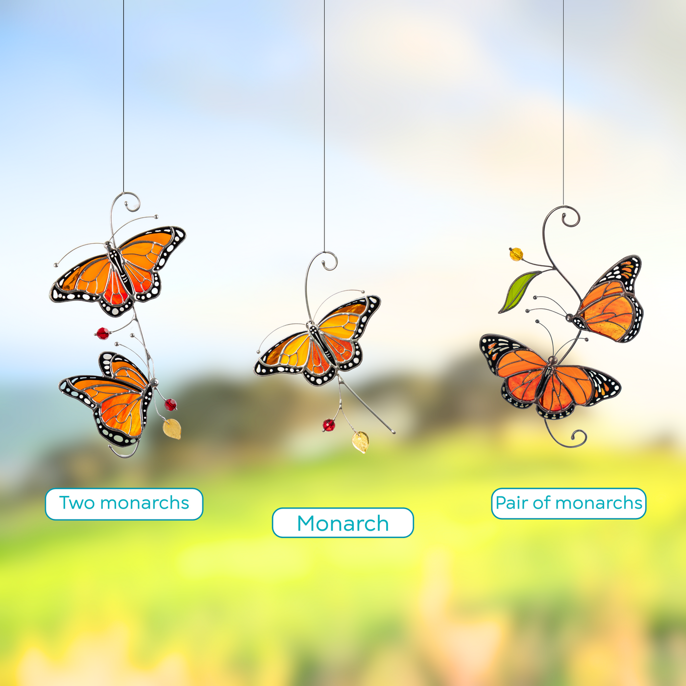Group of stained glass monarch butterflies presented in three different designs: flying monarch, two monarchs with red beads, pair of monarchs.