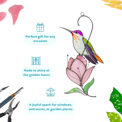 A stained glass hummingbird with vibrant purple and green accents sits gracefully on a pink magnolia blossom.