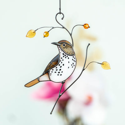 stained glass wood thrush on the branch 