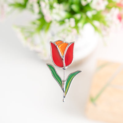 Stained glass brooch of a red flower