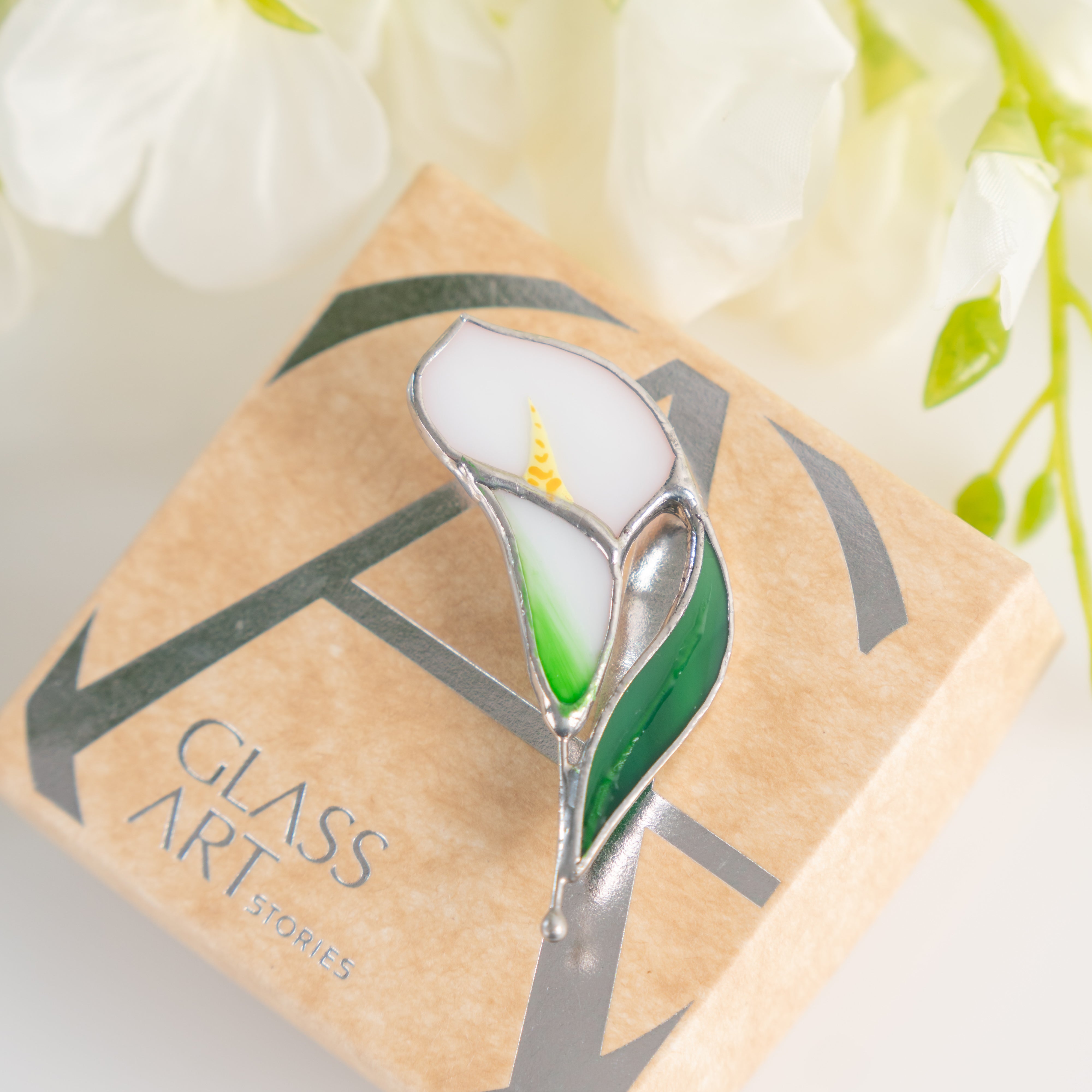 Stained glass calla pin on a brand box