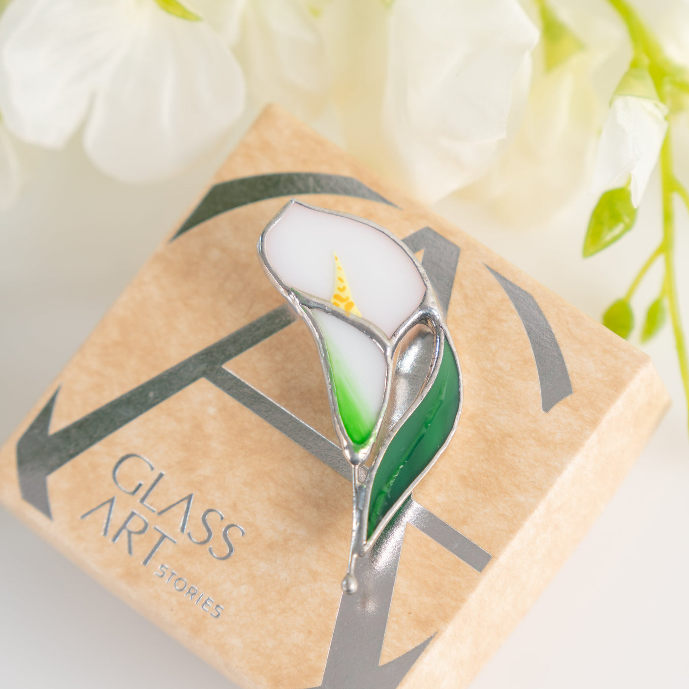 Stained glass calla pin on a brand box