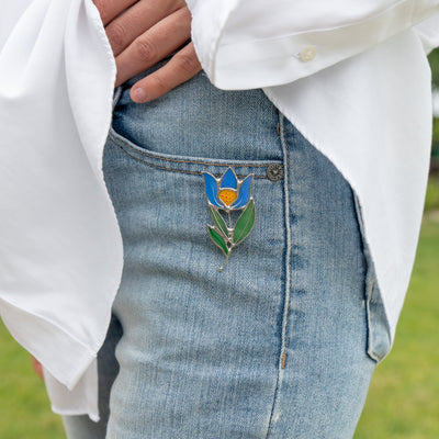Stained glass blue anemone brooch on the jeans