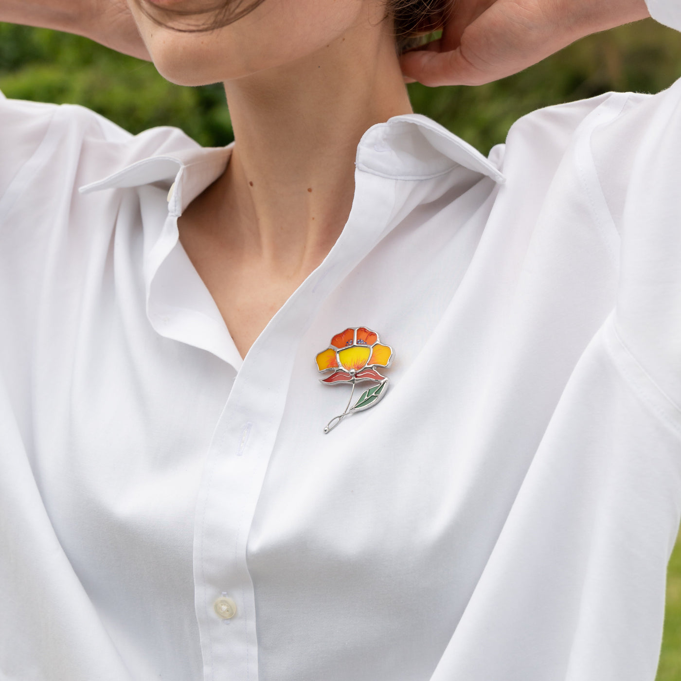 Stained glass peony pin on a white shirt