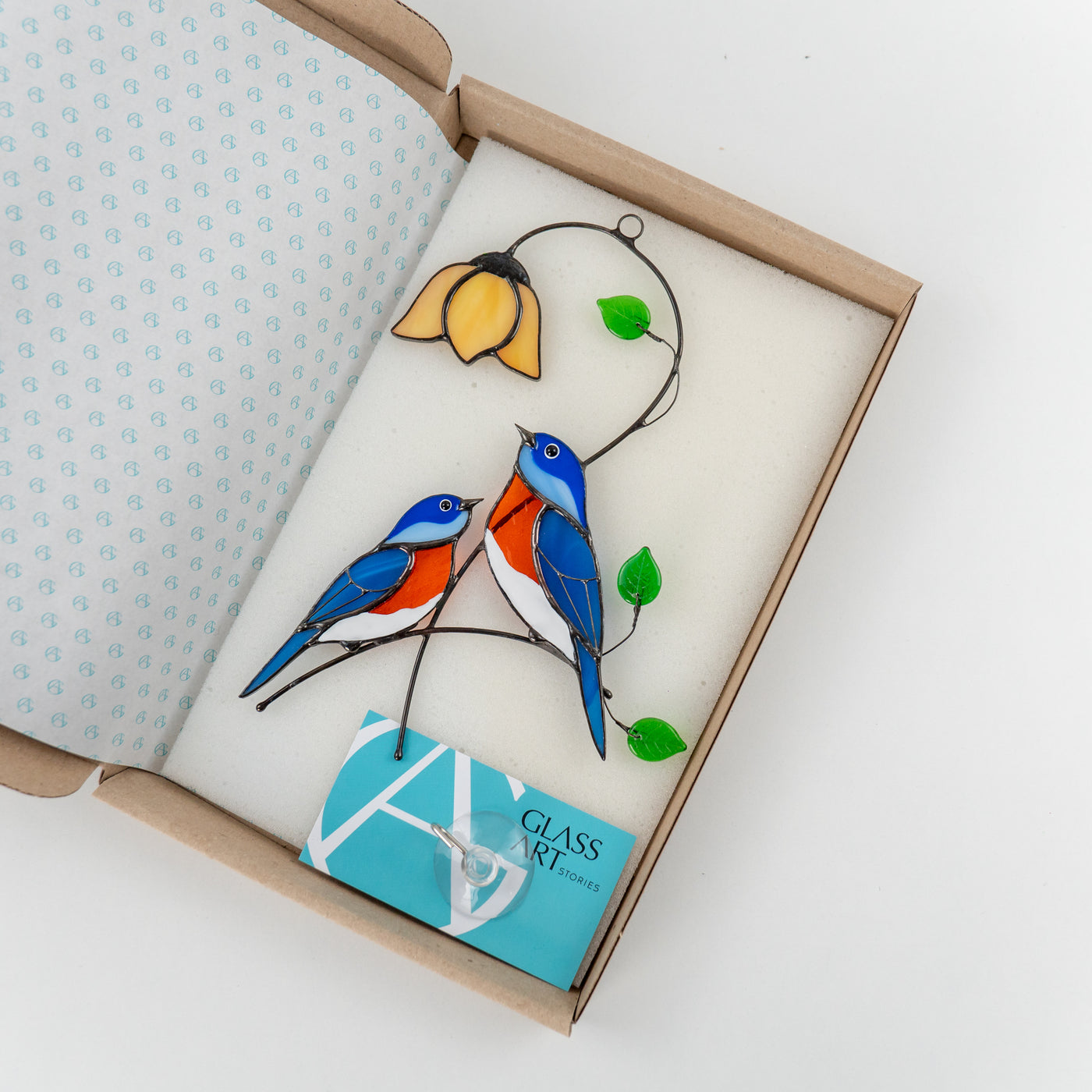 Bluebirds made of stained glass in the brand box of Glass Art Stories 