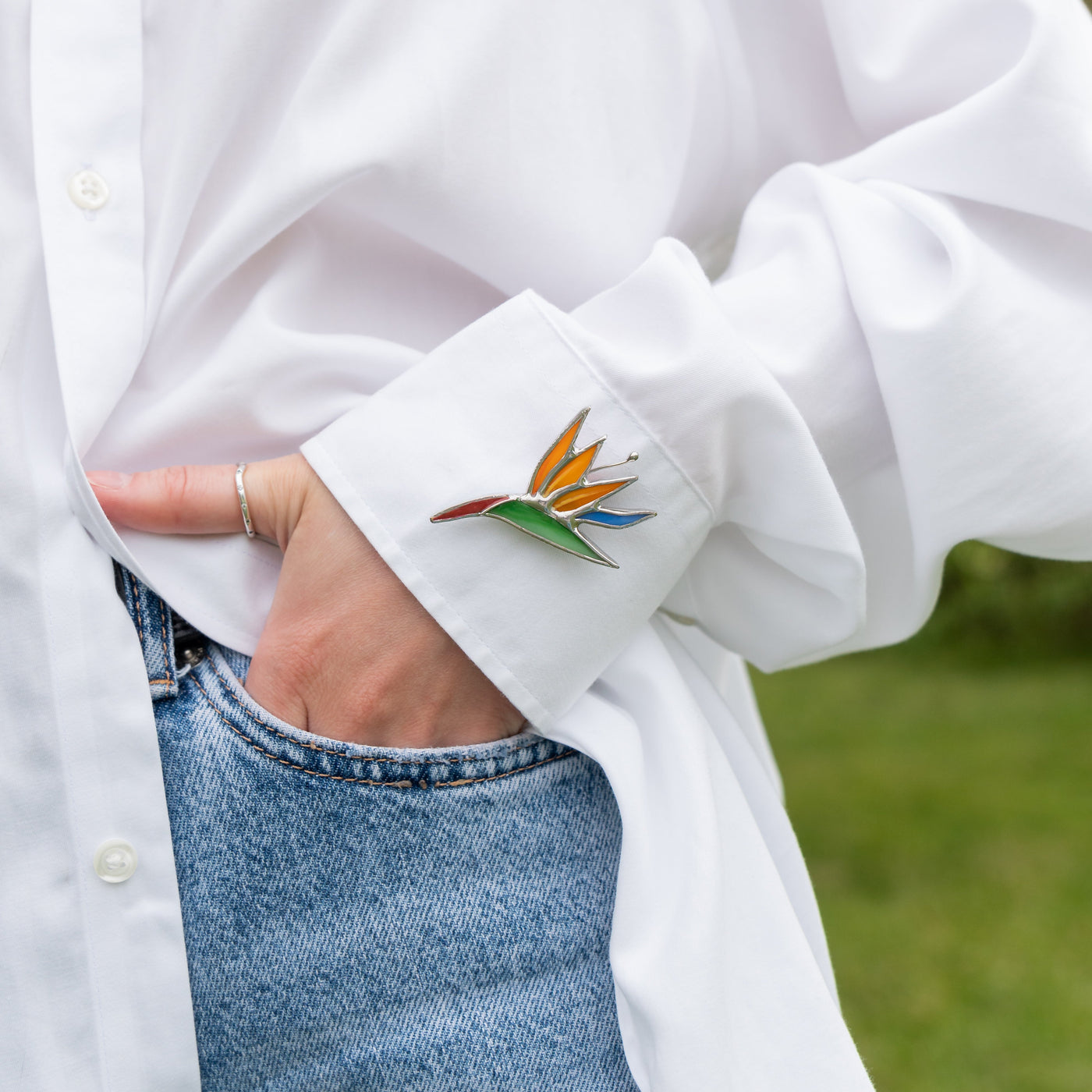 Stained glass pin of a strelitzia flower