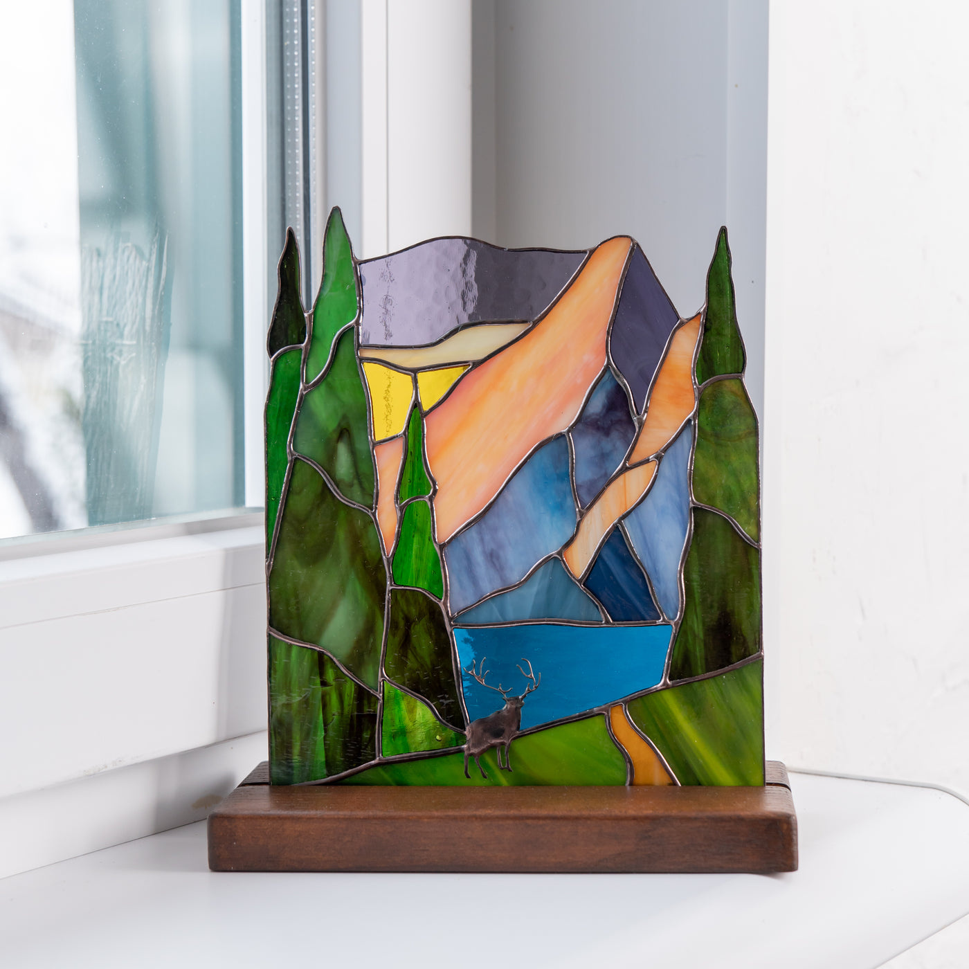 handcrafted glass panel of deer in the forest 