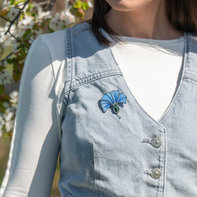 the girl wears the stained glass brooch