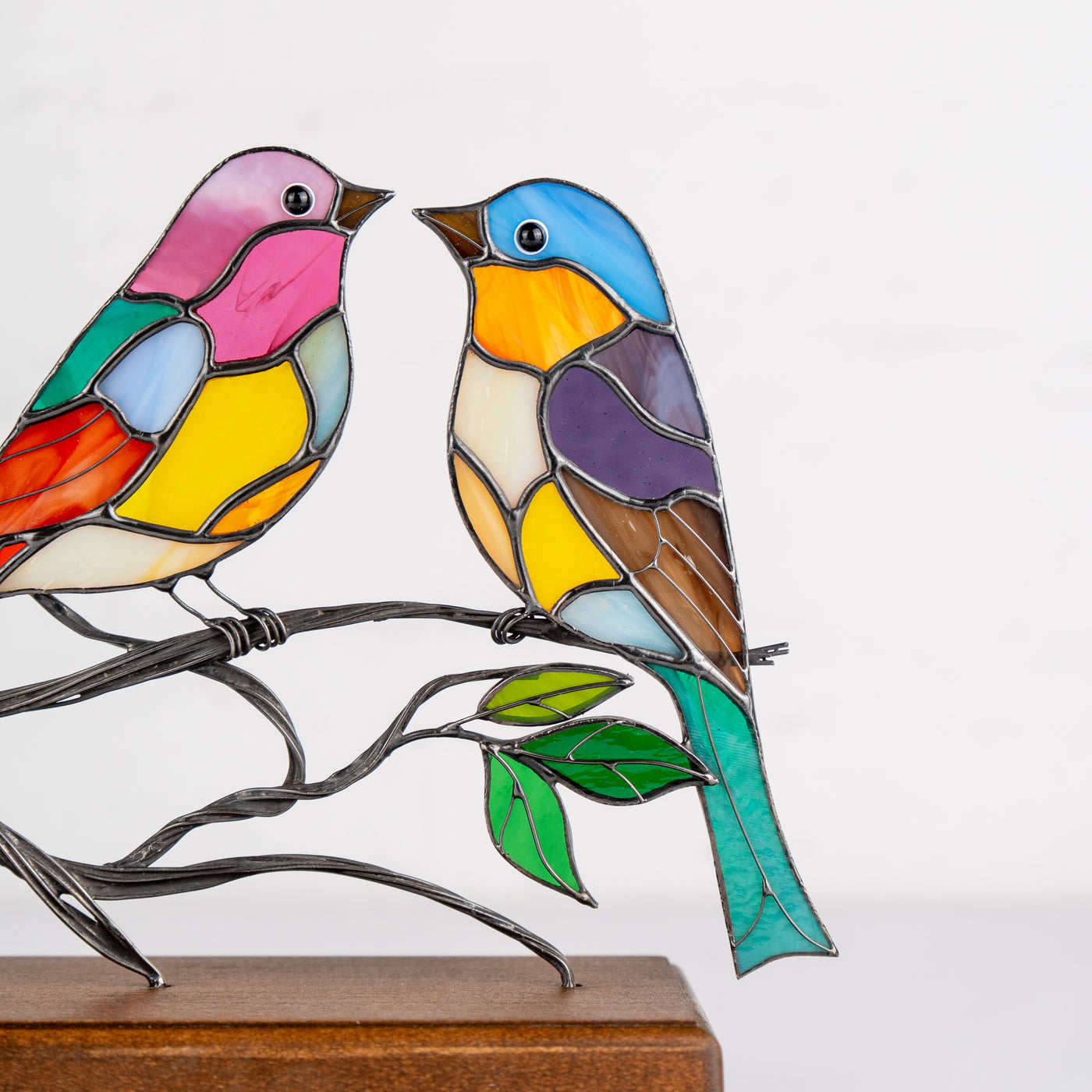 2 modern stained birds on the branch