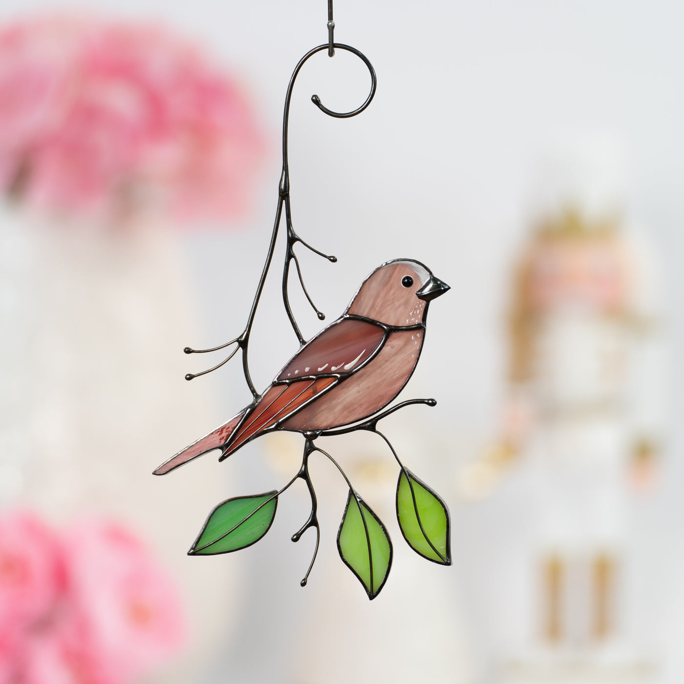 Looking right rosefinch sitting on the branch with three leaves suncatcher of stained glass