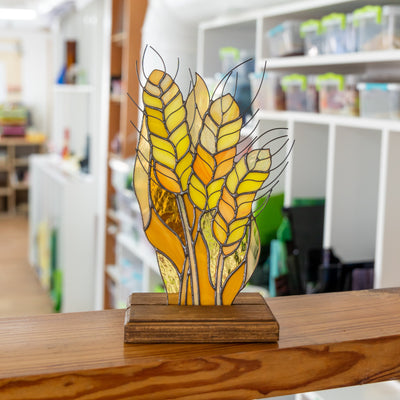 Stained glass yellow wheat panel in a wooden base for table decor