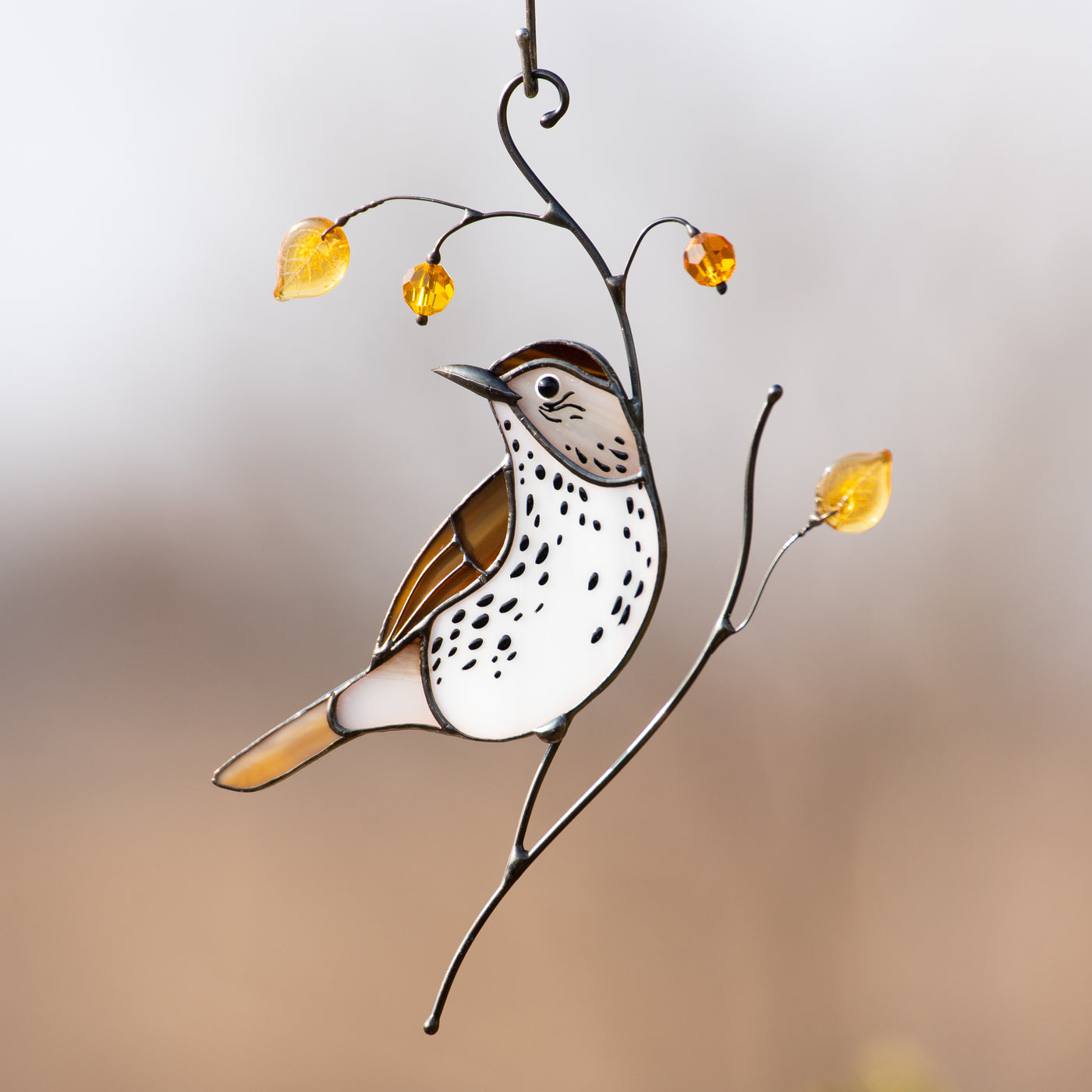 light catcher of wood thrush with yellow leaves and berries
