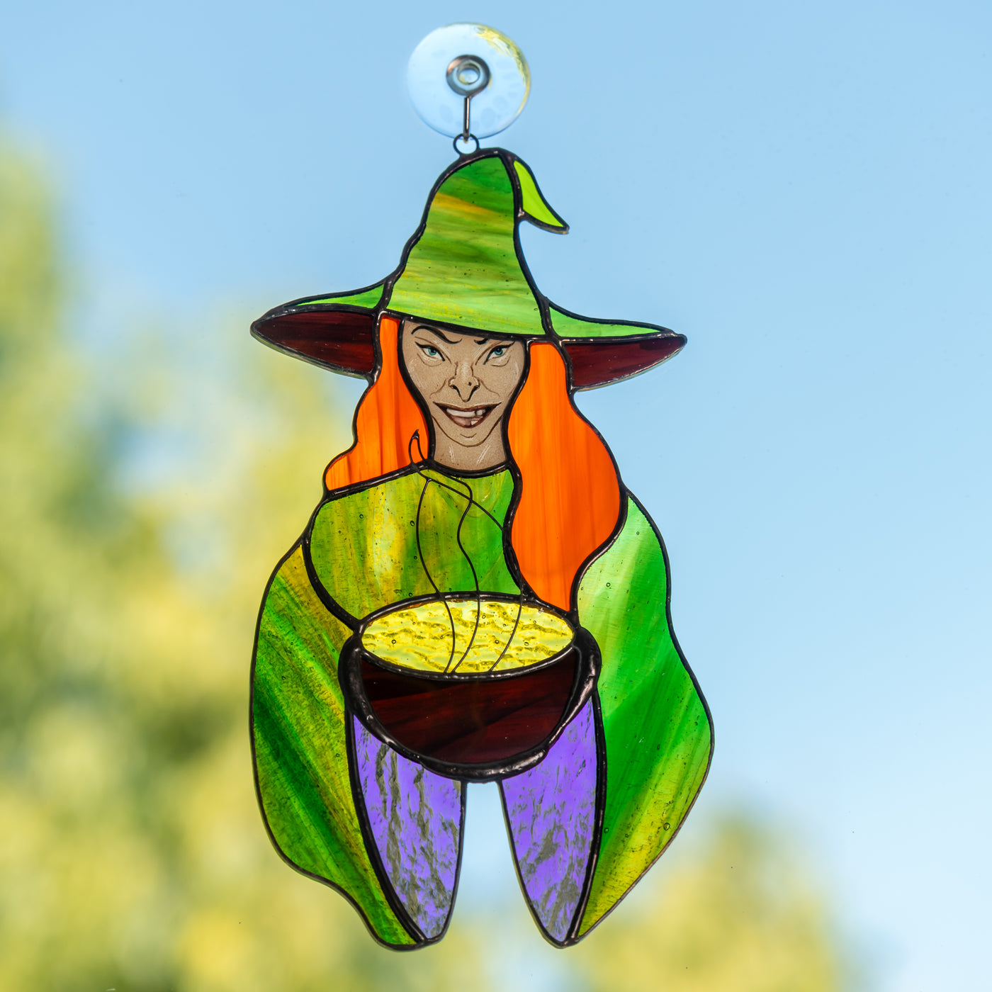 red-haired witch with the pot window hanging of stained glass