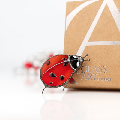Zoomed red ladybug pin of stained glass