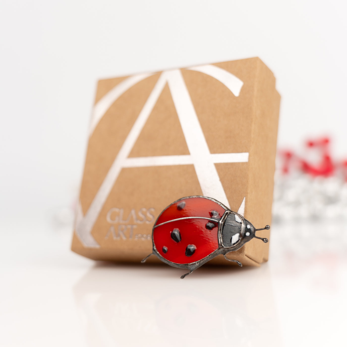 Stained glass ladybug brooch and the brand box