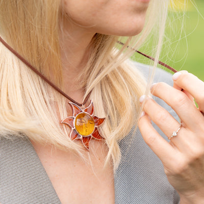 girl with stained glass sun necklace