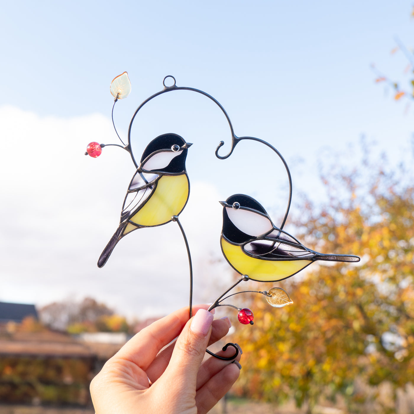 two chickadees sitting on the branch in heart shape stained glass light catcher