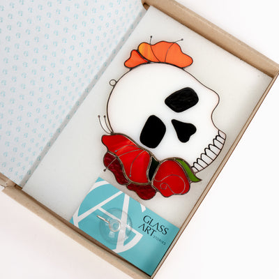 white human skull with red rose in the brand box of Glass Art Stories