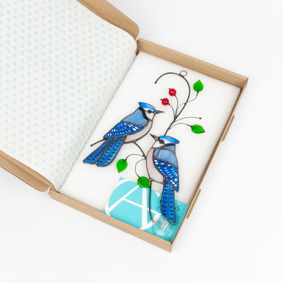 the pair of blue jay birds stained glass window hanging in the brand box