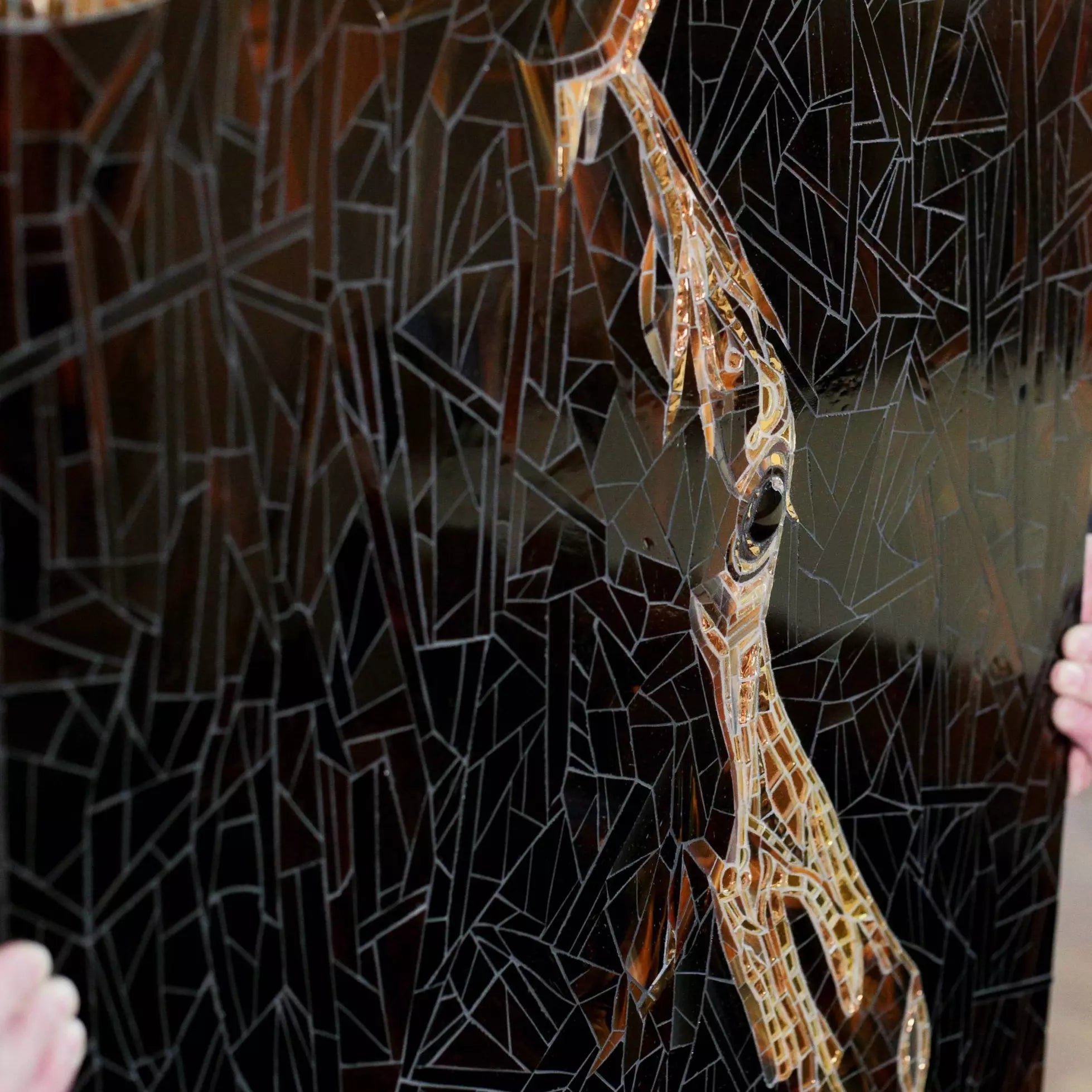 Detailed fragment of horse’s face in black mosaic with intricate glass cuts and highlights