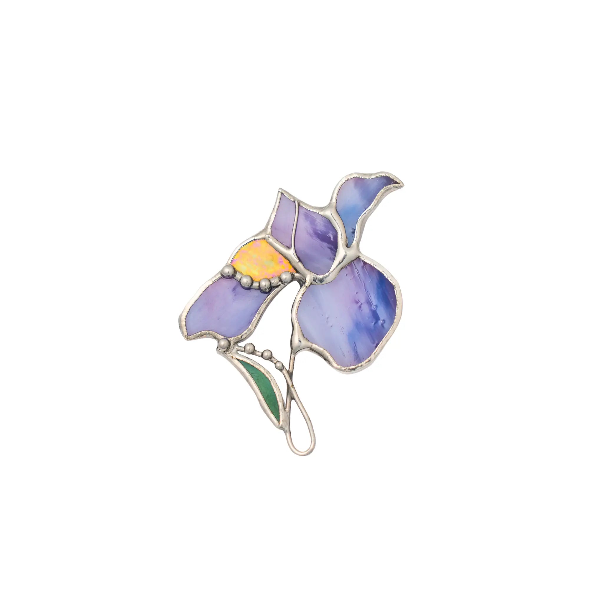 Stained glass brooch with purple, yellow, and green colors on a white background
