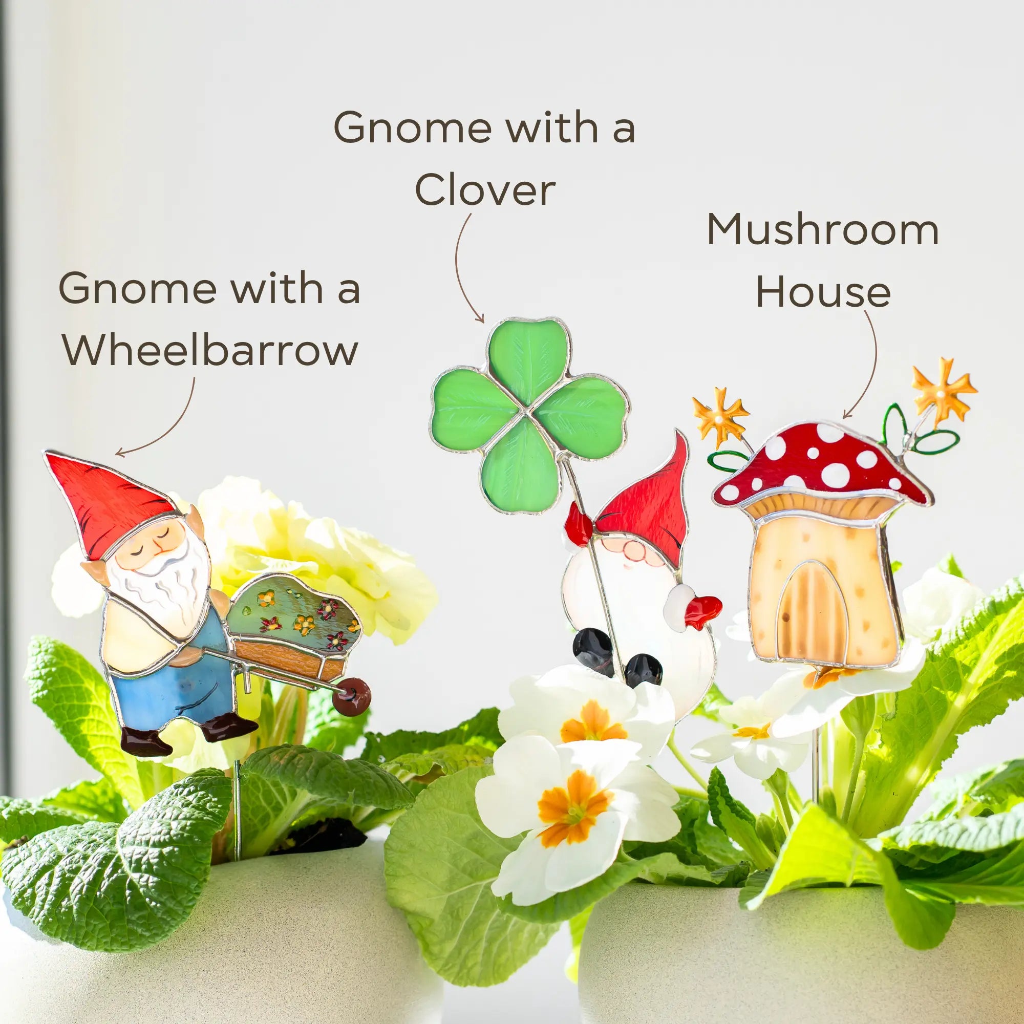 Stained glass garden gnome, mushroom house, and clover with text labels on a white background.