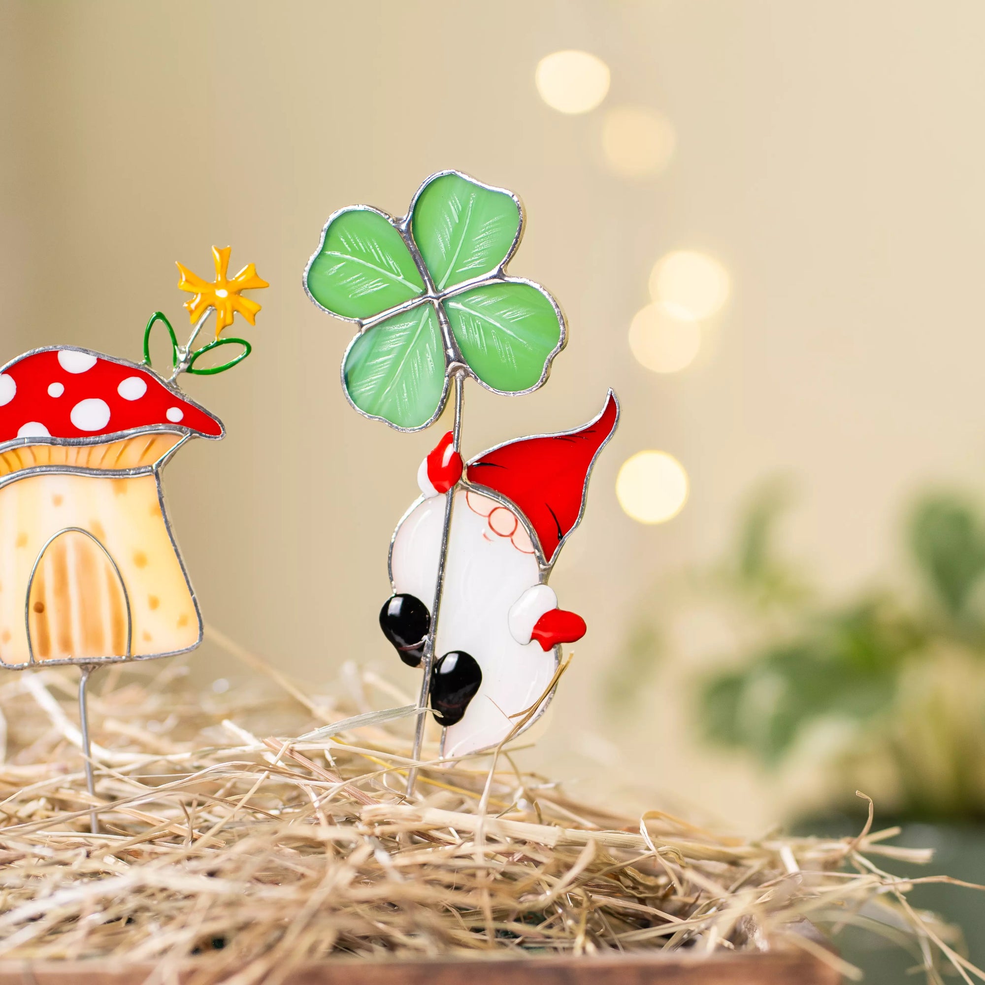 Stained glass garden gnome with mushroom and clover on a blurred background