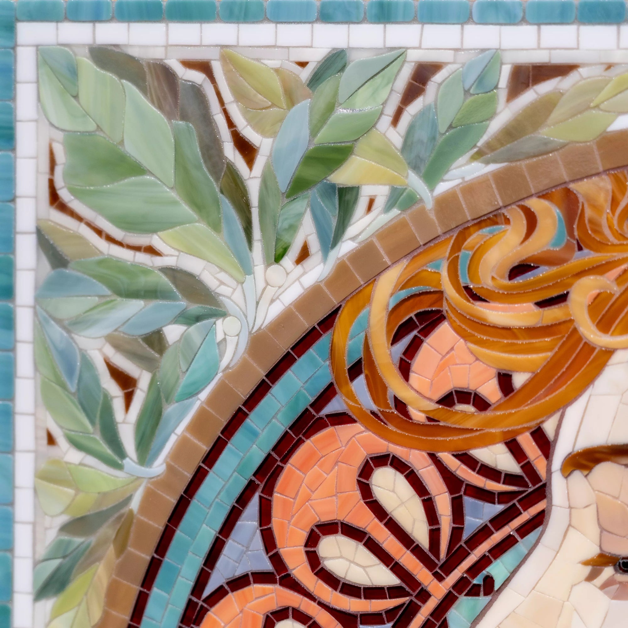 Decorative mosaic portrait inspired by Alphonse Mucha with soft turquoise background, warm amber accents, and botanical elements around the frame.