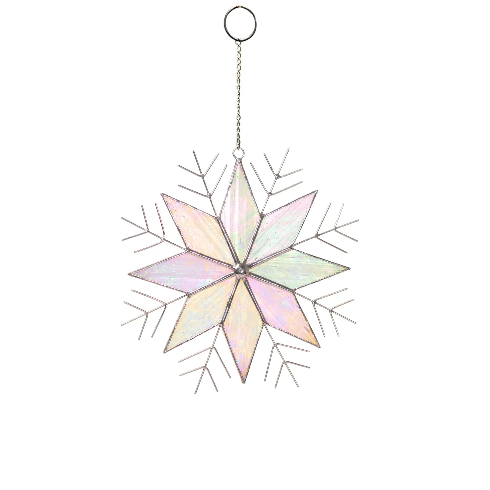 Stained glass snowflake ornament with pastel colors on a white background