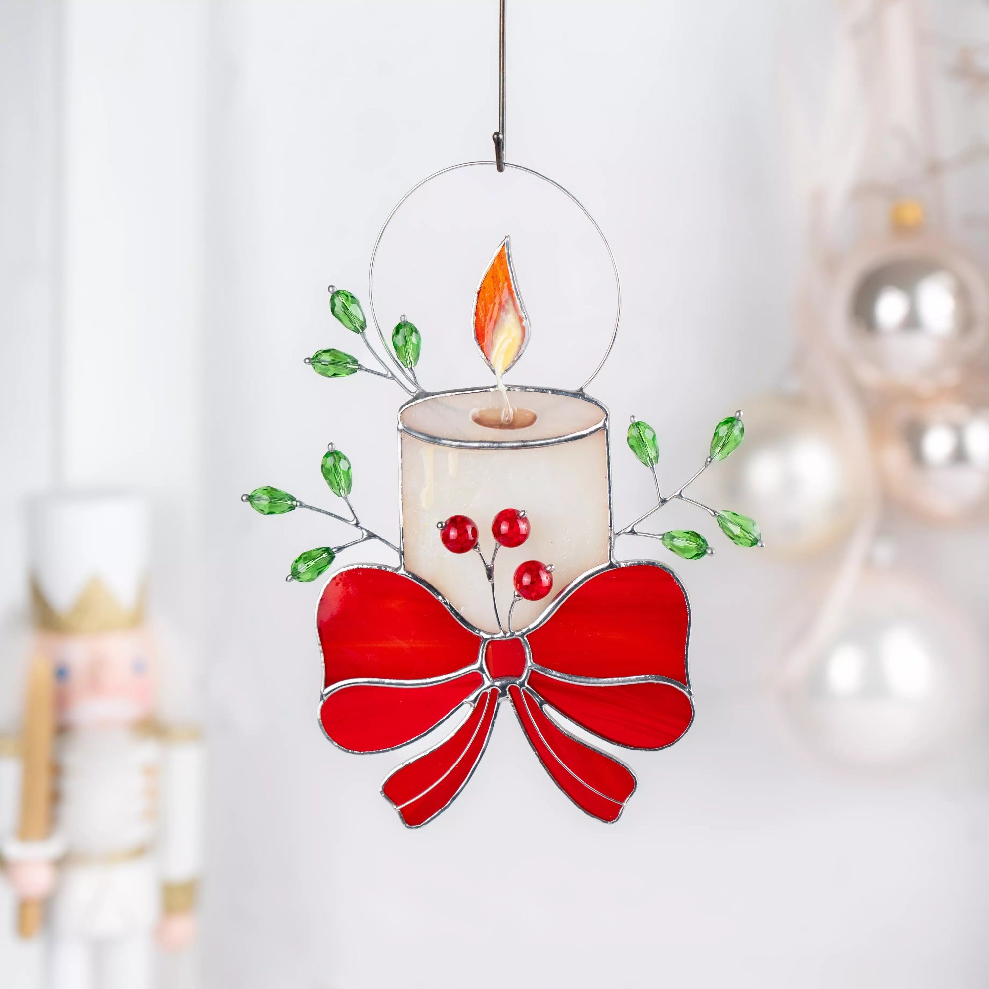 Stained glass window hanging candle with a red bow and berries on a white background