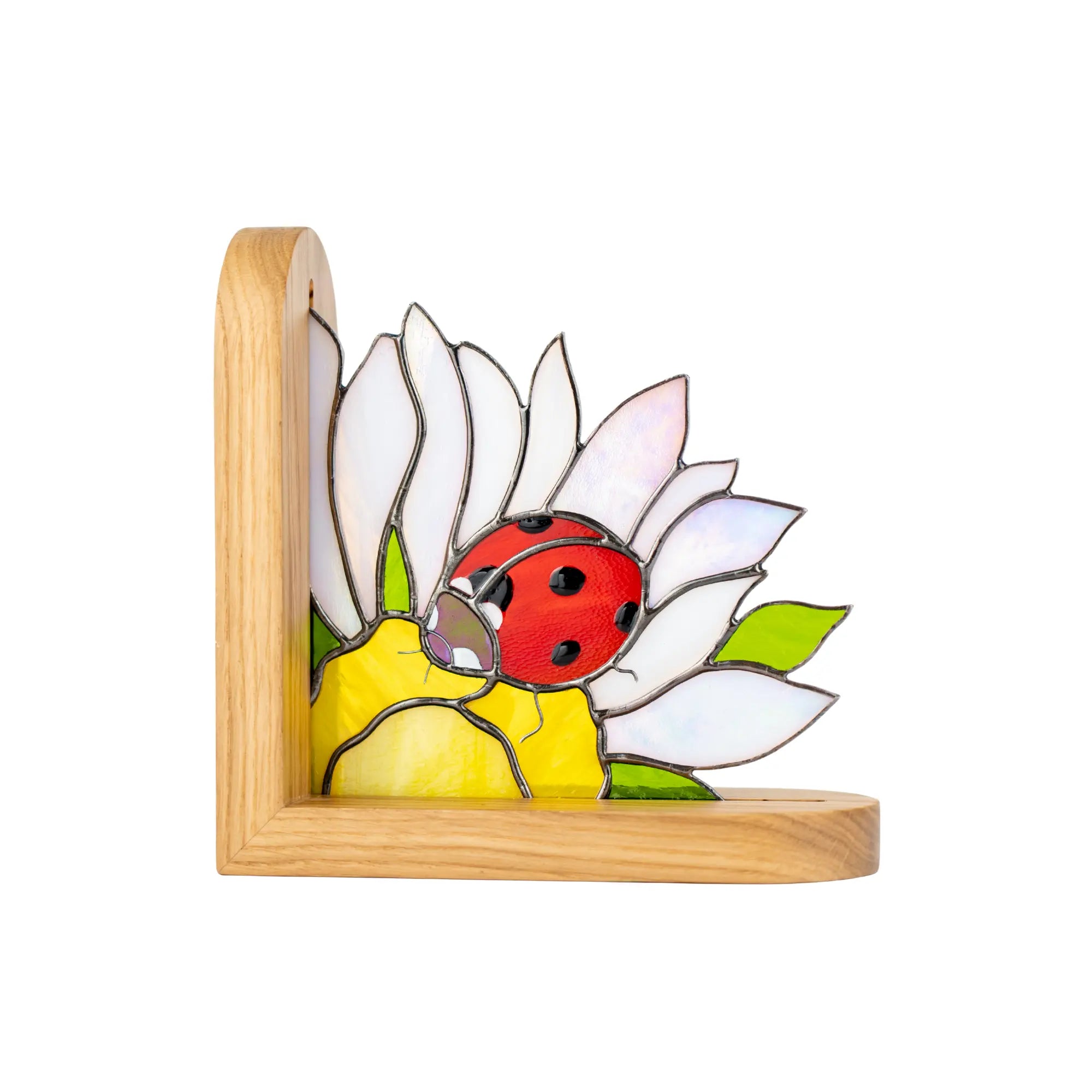 Stained glass bookend panel with a ladybug on a flower in a wooden frame.