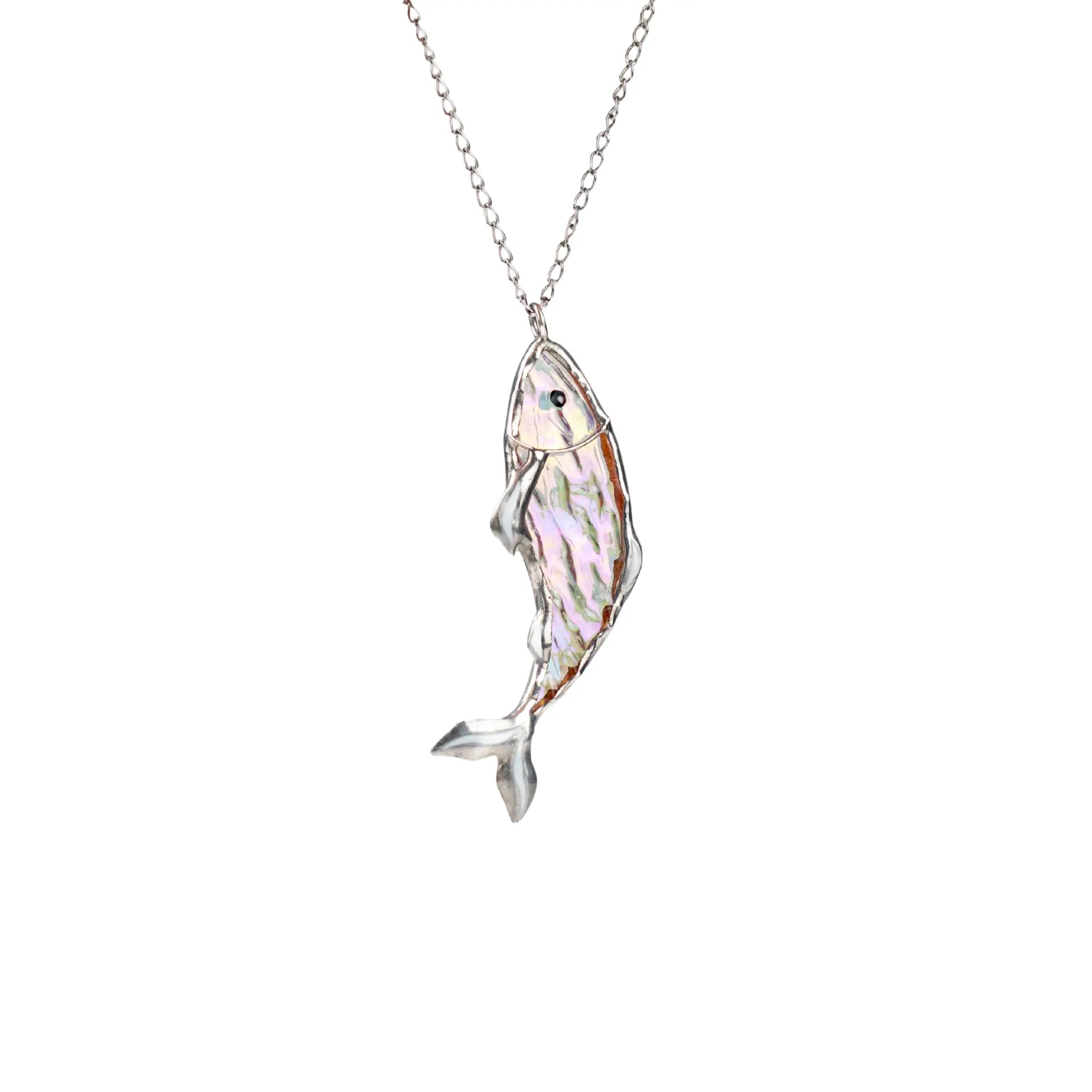 Iridescent fish-shaped pendant in stained glass with soft pastel tones on plain white background