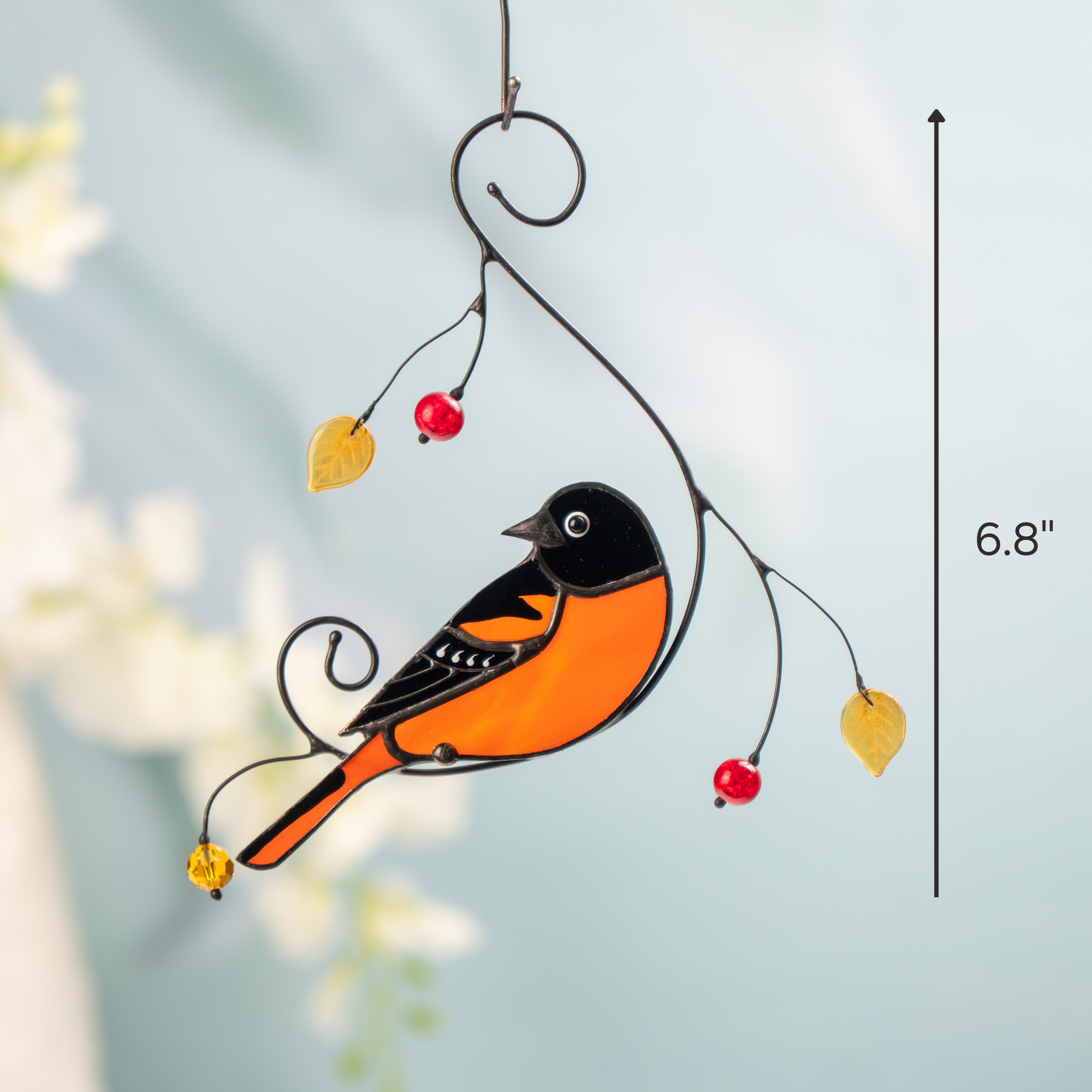 Suncatcher of a stained glass baltimore oriole in orange and black, with beads, sized 6.8 inches