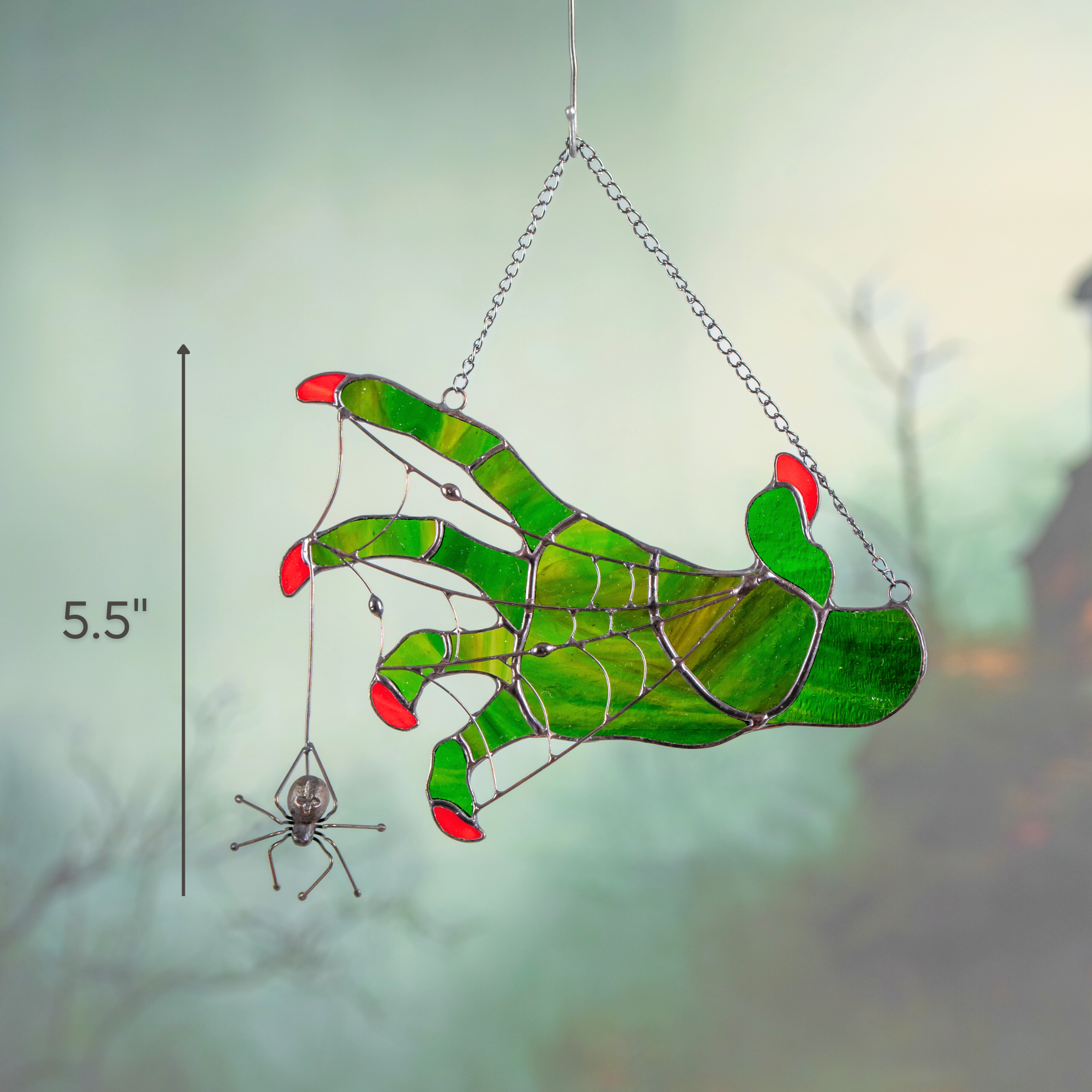Stained glass hand suncatcher displayed against eerie green background with 5.5-inch height label.