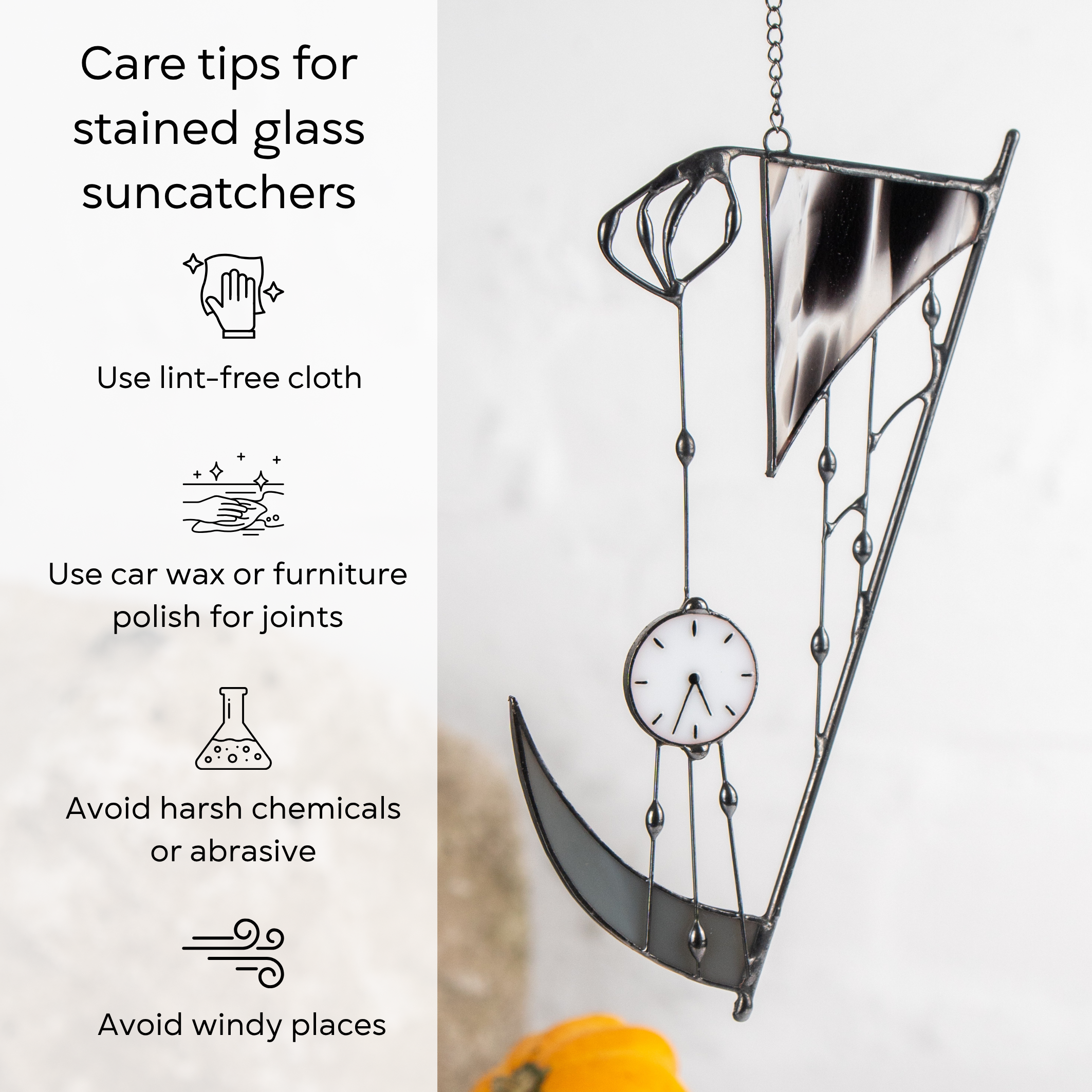 Care tips for stained glass next to the hanging “Hand of Death” suncatcher on white wall with pumpkin: use lint-free cloth, polish joints with car wax or furniture polish, avoid harsh chemicals, and windy places.
