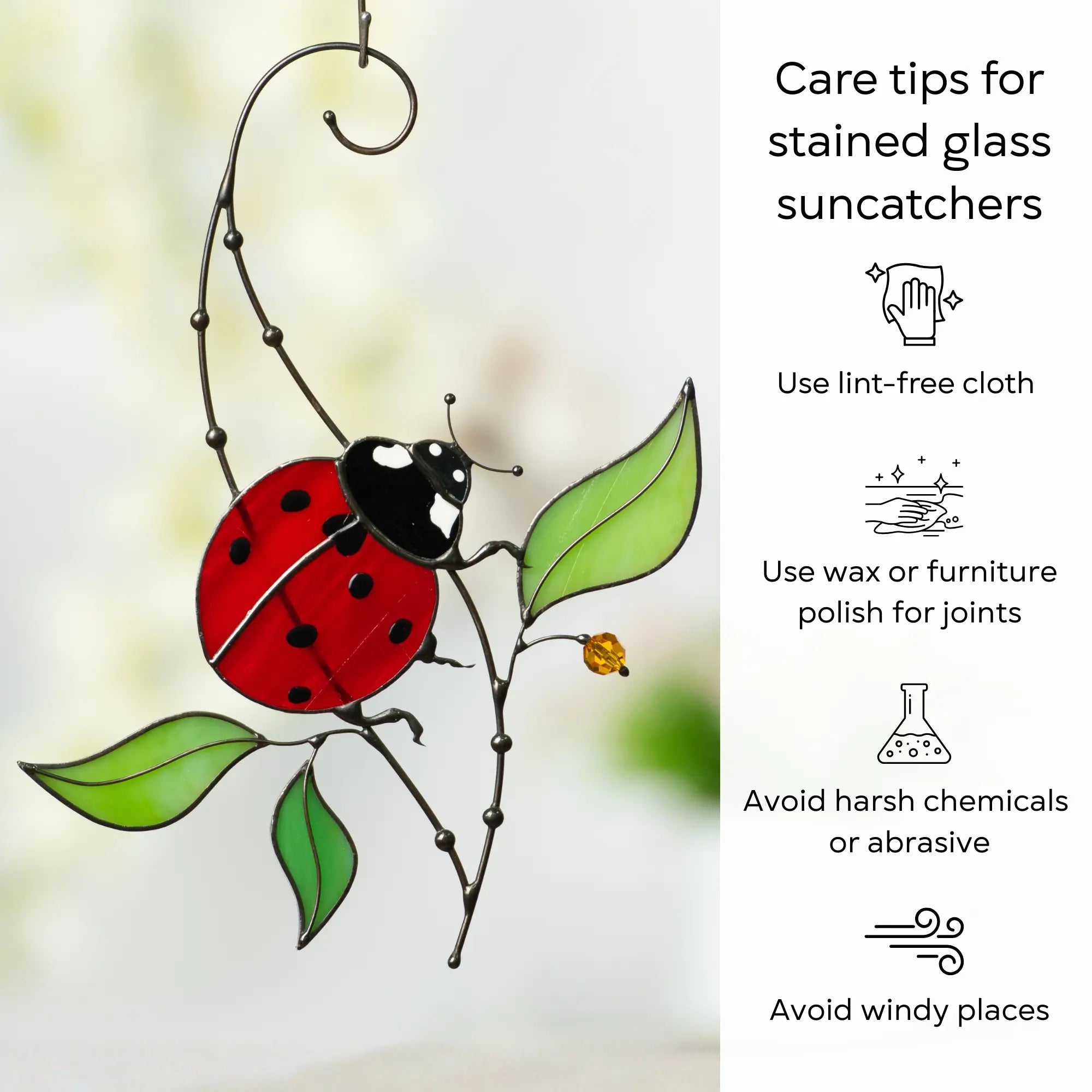 Stained glass ladybug suncatcher with care tips on a blurred background: use lint-free cloth, polish joints with car wax or furniture polish, avoid harsh chemicals, and windy places.
