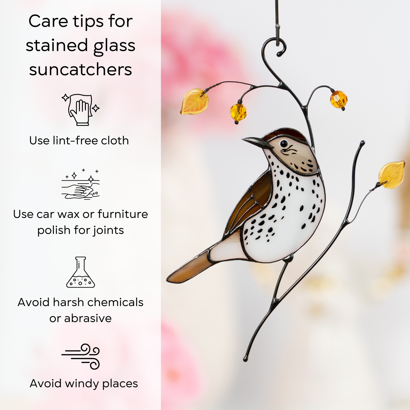 Close-up of stained glass wood thrush hanging indoors with yellow beads and care tip icons beside