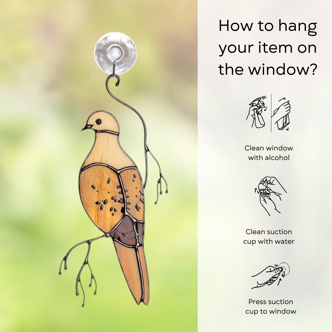 Glass mourning dove attached to window with a suction cup and hanging instructions on side: clean window and suction cup, press a cup to the surface.