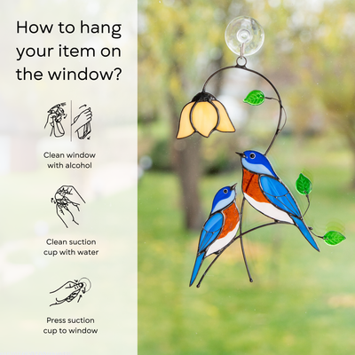 Bluebird suncatcher hanging on window with step-by-step hanging guide.