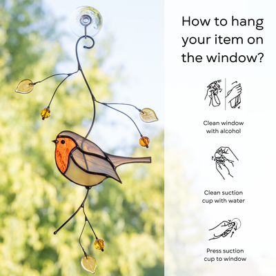 Robin suncatcher shown hanging on glass with step-by-step instructions for proper suction cup use: clean window and suction cup, press a cup to the surface