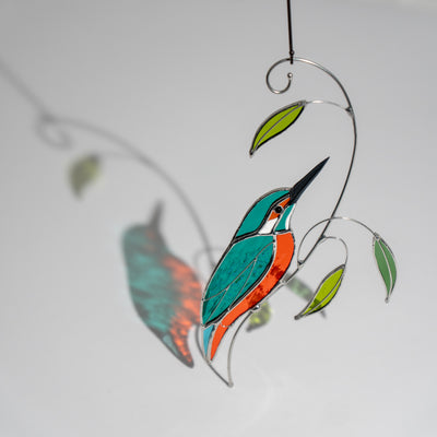 Stained glass kingfisher bird with colorful shadow cast on the background, vivid and playful.