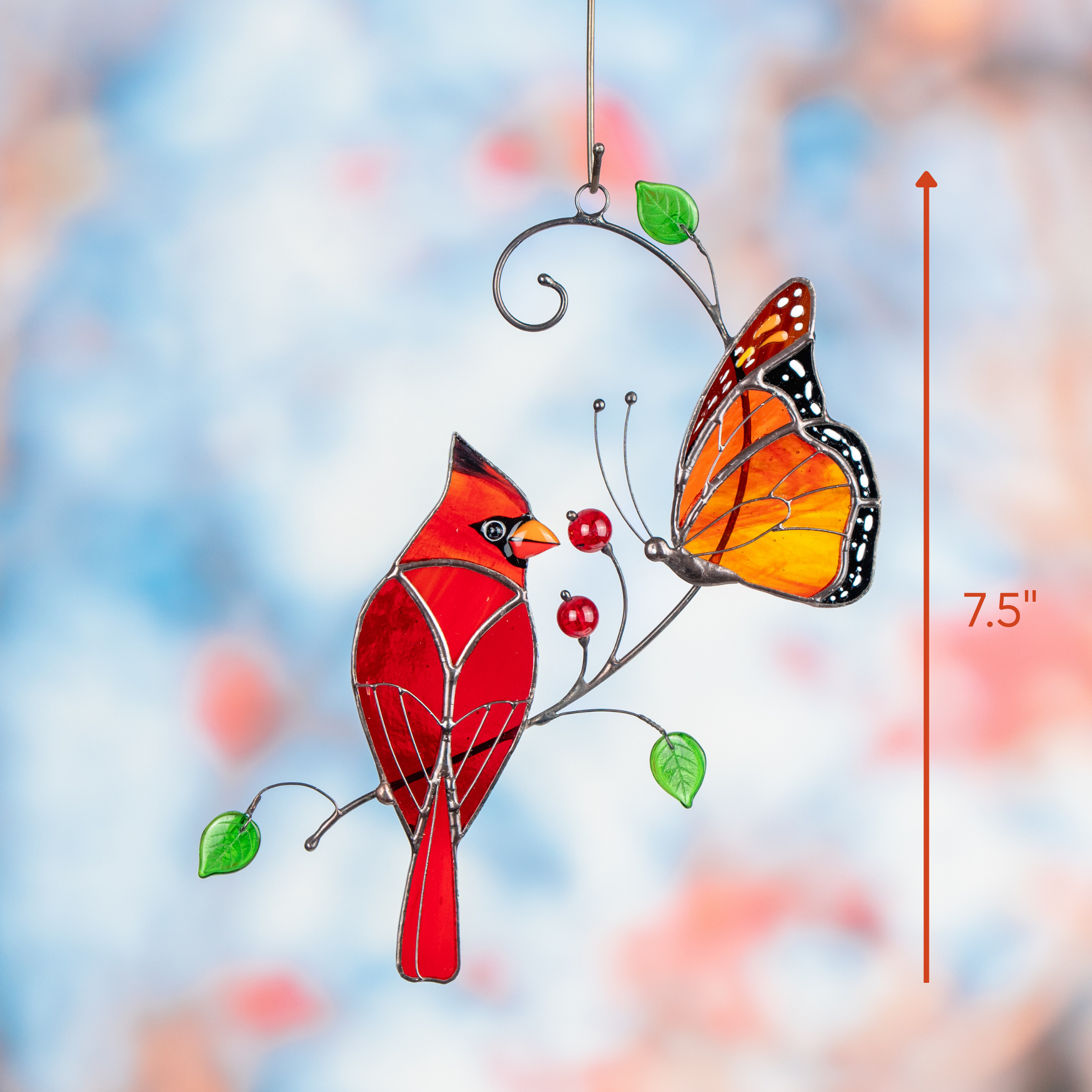 Hanging stained glass suncatcher showing cardinal and monarch butterfly with a 7.5-inch size indicator.