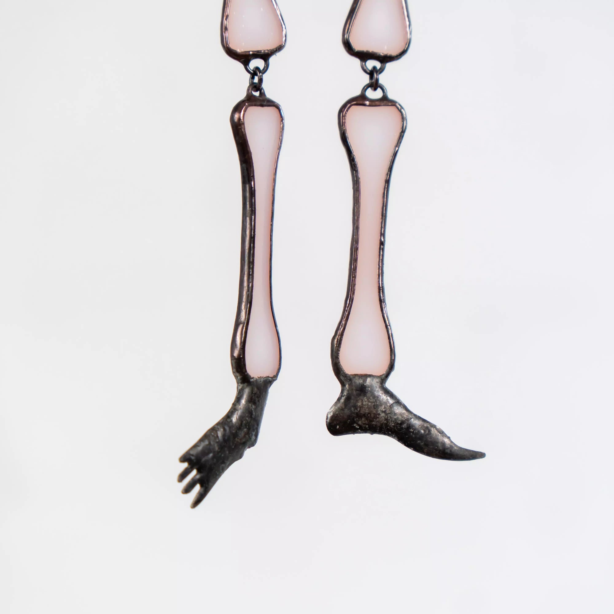 Close-up of skeleton’s feet and lower legs made from soft white stained glass