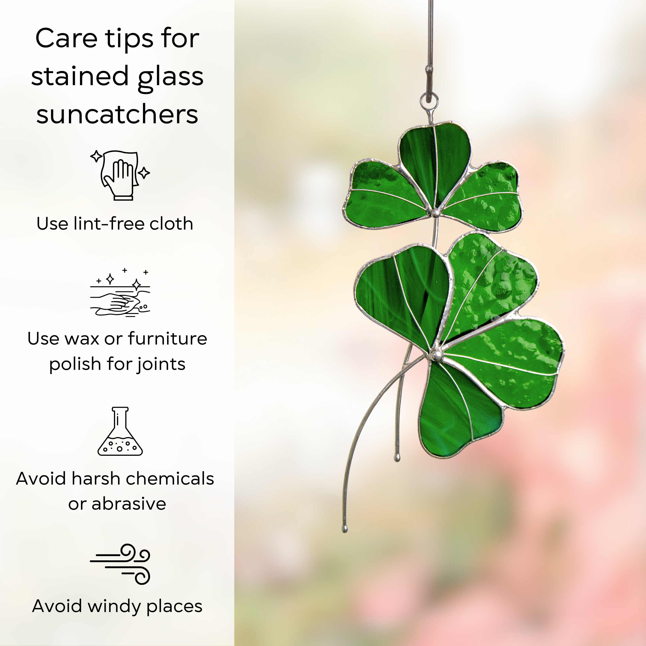 Clover-shaped green glass suncatcher hanging on a wire outdoors with soft background blur and care tips beside: use lint-free cloth, polish joints with car wax or furniture polish, avoid harsh chemicals, and windy places.