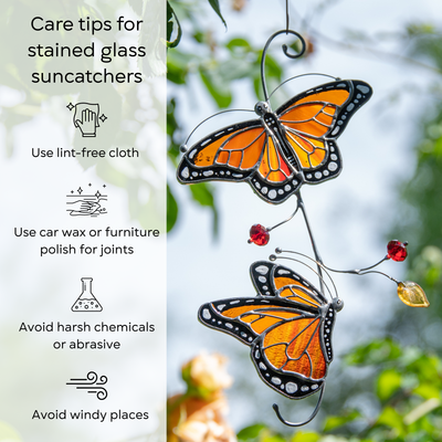 Stained glass monarch suncatcher hanging outdoors among tree branches, care tips beside: use lint-free cloth, polish joints with car wax or furniture polish, avoid harsh chemicals, and windy places.