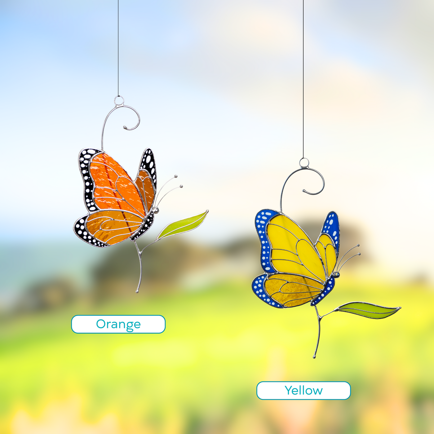 Stained glass monarch butterflies in orange and ukrainian colors hanging in a blooming garden with vibrant background.
