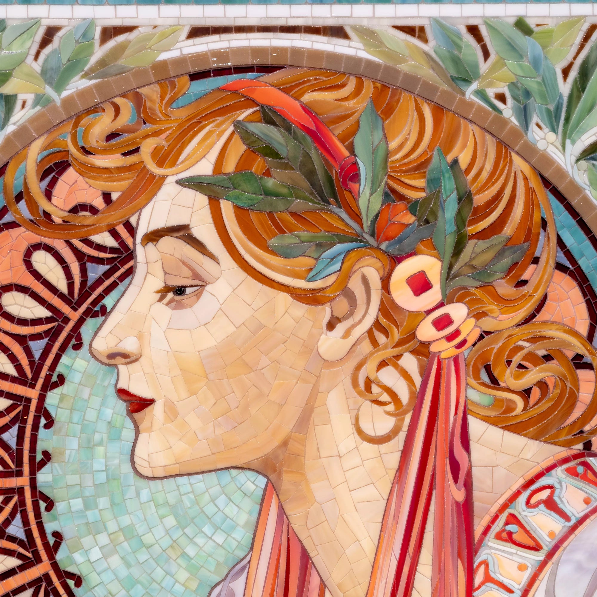 Detailed view of mosaic glass pieces highlighting hair strands, decorative ribbons, and layered color transitions.