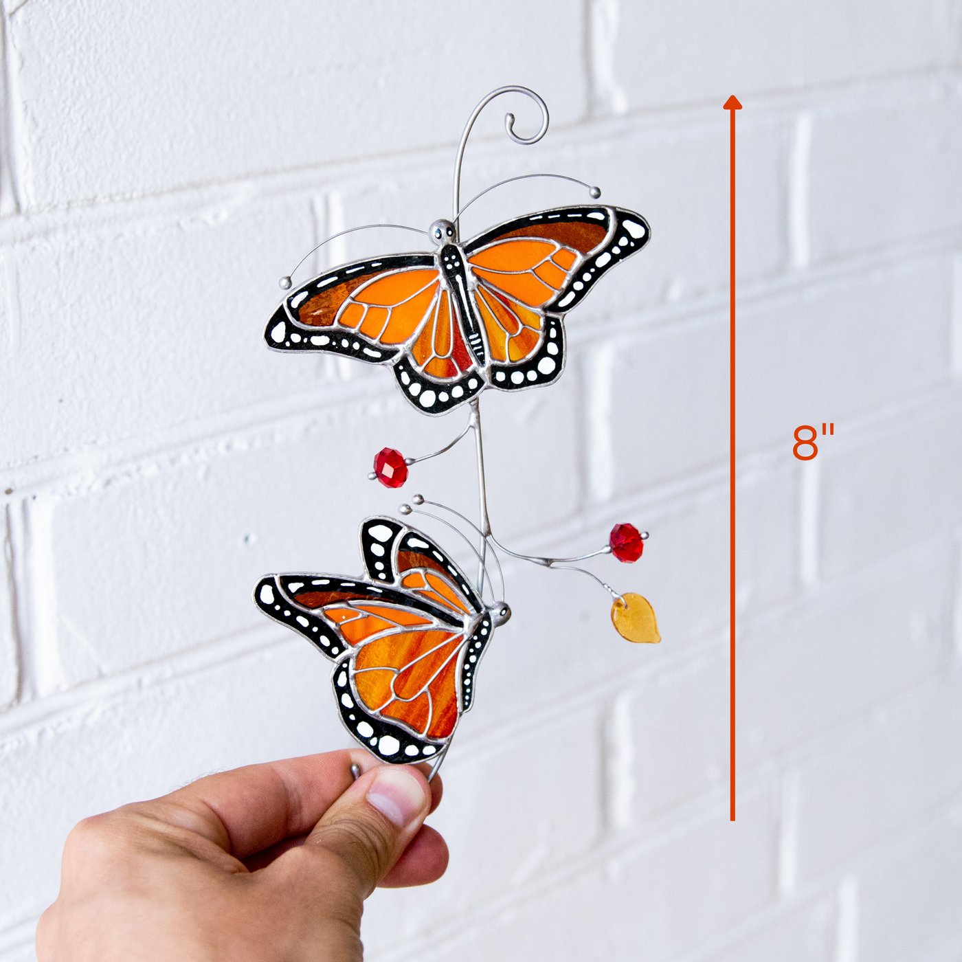 Stained glass monarch butterflies with size indicator showing 8 inches.
