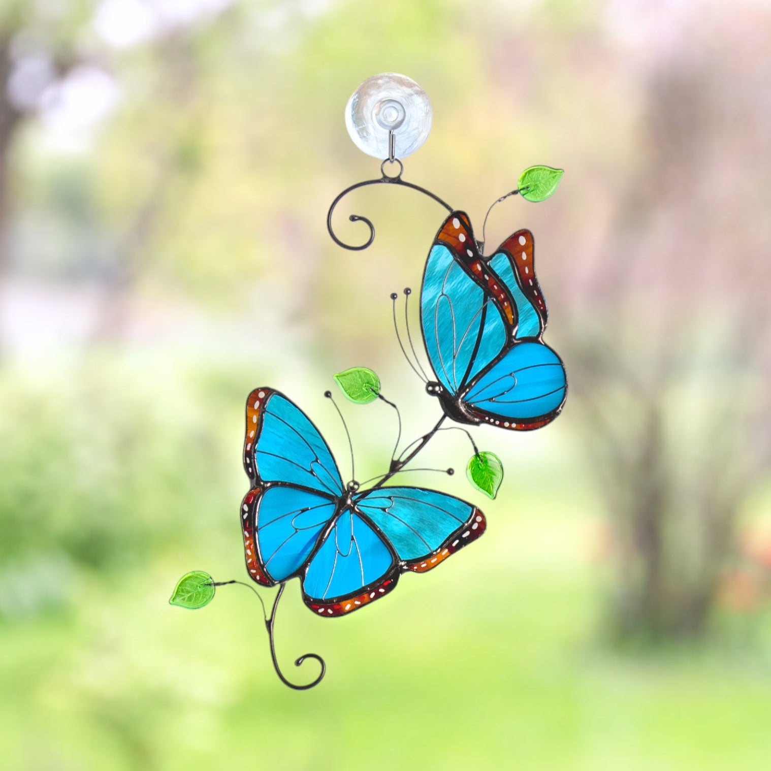 Stained glass morpho butterflies in vivid blue with green leaves, sparkling with a warm sunlit background.
